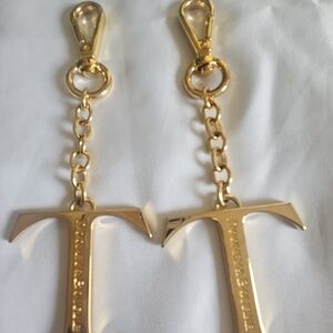 This is a Dooney & Bourke Monogram Pendant Key Chains. Selling The Pair/ Single